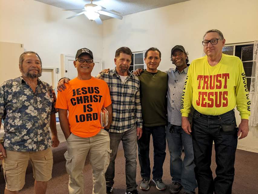 Pastor Joe Cinquina poses with several men of the church at his farewell party.